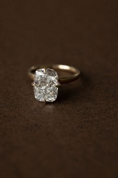 a diamond ring sitting on top of a table