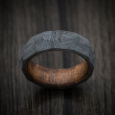 This Carbon Fiber ring features:- 7mm width shown- Faceted Shape- Chestnut Wood Sleeve Rustic Untreated Ring As A Gift, Rustic Untreated Ring For Gift, Rustic Untreated Rings For Gift, Carbon Fiber Ring, Chestnut Wood, Carbon Fiber Rings, Men's Ring, Chestnut, Carbon Fiber