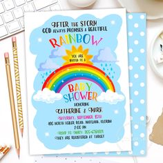 a rainbow baby shower is on the table next to a keyboard and cup with pencils