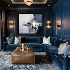 a living room filled with blue couches and pillows in front of a painting on the wall