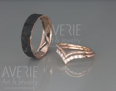 two wedding bands with diamonds on them sitting next to each other in front of a gray background