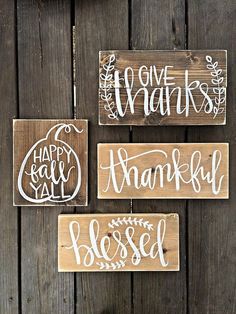 three wooden signs that say happy thanksgiving and one says happy fall