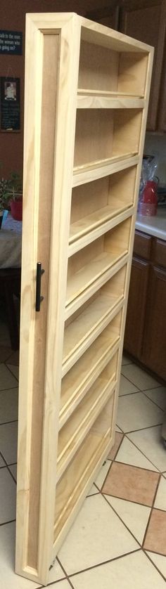 a large wooden cabinet sitting on top of a tiled floor