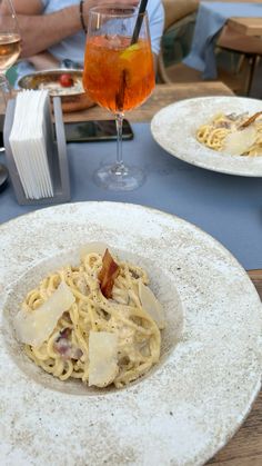 two plates with food and drinks on a table