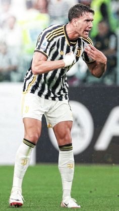 a man standing on top of a soccer field