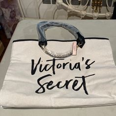 A Beautiful Brand New Victoria Secret Beach Bag With Tag In Off White And Handles In Black With A Chain In Front For A Nice Touch. It’s Length Is 16 Inches By Width About 6 Inches And Height 12 3/4 Inches. A Zipper Compartment Inside Of The Bag. Victoria Secret Beach, Secret Beach, Victoria Secret Bags, Chanel Deauville Tote Bag, Black Cream, Beach Bag, Victoria Secret, Travel Bags, 6 Inches