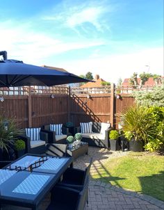 an outdoor patio with table, chairs and umbrella