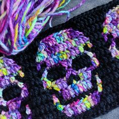 a crocheted bag with a skull on it