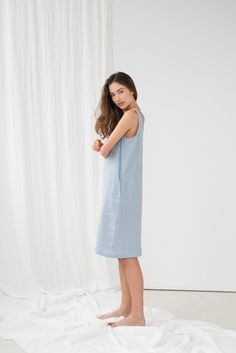 "Minimalist UMA sleeveless dress in light blue. - length is ± 105 cm (41.3\") (depends on size) - with pockets - straight cut - loose fit NOTE: This dress is oversized, please have this in mind when choosing your size. DETAILS: - 100 % European, pre-washed medium weight linen (205 g/m²) - the model is 180 cm (5′11″) high, wearing size S. - model measurements: bust 84 cm (33\") / waist 61 cm (24\") / hips 92 cm (36\") - color in the picture - light blue (you can choose other color on the right) M Summer Dress Midi, Midi Linen Dress, Linen Nightgown, Linen Sleepwear, Linen Summer Dress, Blue Summer Dress, Sleeveless Linen Dress, Audrey Dress, Linen Summer