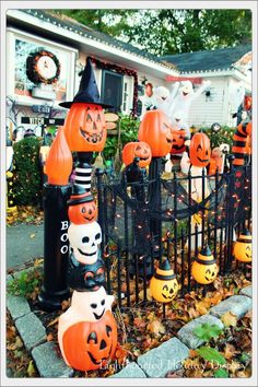 pumpkins and jack - o'- lanterns are on display in front of a house