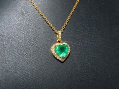 Heart-shaped Emerald Necklaces For Anniversary, Heart-shaped Emerald Necklace For Anniversary, Anniversary Heart-shaped Emerald Necklace, Gold Emerald Heart Pendant Jewelry, Elegant Green Heart Cut Jewelry, Heart-shaped Emerald Jewelry For Valentine's Day, Valentine's Day Heart Shaped Emerald Jewelry, Emerald Heart Cut Necklace For Anniversary, Heart Cut Emerald Jewelry In Yellow Gold