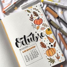 an open notebook with autumn lettering on it