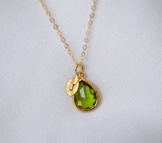 This beautiful simulated peridot necklace would be a perfect gift for a wedding, birthday, anniversary, graduation, or for any occasion. The silver, gold-plated, or rose gold peridot teardrop-shaped pendant is made of glass and shines beautifully in the light. It measures approximately 12.5x16mm and is hung on a 16", 18" or 20" chain. The chain options include silver-plated, gold-plated, rose gold-plated, sterling silver, 14K gold-filled, or 14K rose gold-filled metal. The chains are dainty and Ring Inspo, Peridot Necklace, Birthstone Earring, Leaf Charms, Rose Gold Necklace, Birthstone Necklace, Delicate Necklace, Gorgeous Earrings, Birthday Anniversary