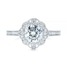 a white gold engagement ring with an oval center surrounded by round brilliant cut diamonds