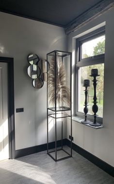 a room with a mirror, vases and other items on the wall next to it