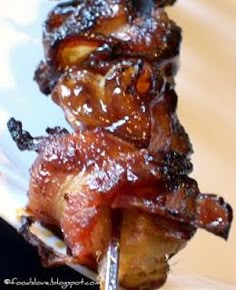 bacon on a fork is sitting on a plate