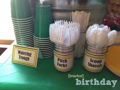 there are many plastic cups and spoons on the table with each one's name