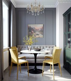 a living room filled with furniture and a chandelier hanging from the ceiling over a table