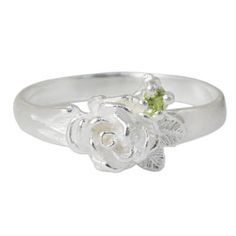 Textured petals nestle beside a sparkling peridot in a beautiful design by Sarote Lochotinunt. Handcrafted of sterling silver this ring is crowned by a stylized camellia blossom. .925 Sterling silver Elegant Green Flower Ring In Sterling Silver, Elegant Green Sterling Silver Flower Ring, Silver Flower Ring With Birthstone, Green Sterling Silver Flower Wedding Ring, Green Sterling Silver Flower Ring For Wedding, Mens Silver Pendants, Silver Casting, Single Stone Ring, Metal Forming