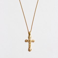 Our detailed cross pendant is placed on our 1mm cable chain for a simplistic touch to the necklace. This necklace is great to be worn as a statement piece in a layered look. We recommend pairing with The Angel Chain in 16" and The Beloved Chain in 18". Stainless Steel 18k Gold Plated Hypoallergenic Pendant size: 3.3" x 1.9" Chain width: 2.2mm Chain length: 18" with 2" extender Gold Necklaces With Cross Pendant And Cable Chain, Gold Cross Pendant Necklace On Cable Chain, Gold Cross Pendant Necklace With Cable Chain, Gold Necklace With Cross Pendant And Cable Chain, Crucifix Cross Necklace With Figaro Chain As Gift, Cross Pendant Necklace With Cable Chain As Gift, Yellow Gold Crucifix Necklace With Delicate Chain, Gold Crucifix Charm Necklace In Minimalist Style, Gold Minimalist Crucifix Charm Necklace