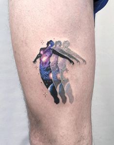 a man's leg with a tattoo on it that has an image of a person in space