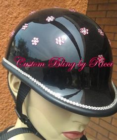 a mannequin wearing a black helmet with pink flowers on it