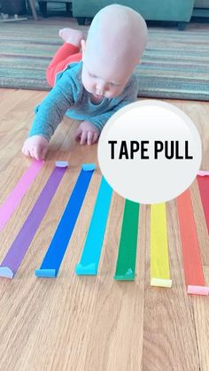 a baby crawling on the floor with tape pull in front of it's face