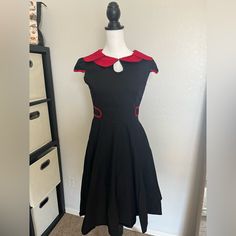 Orders Ship Within 1-2 Business Days. Retro Dress, Vintage Dress. Keyhole Neckline With Eyelet Closure. Hidden Side Zipper From Under Arm To Hip. I’ve Had This Dress And Never Found The Right Occasion For Itone Wash After Purchasing, But Never Worn Out. Good Condition. No Tears, No Fade, No Stains. 97%Cotton 3% Spandex Taken Laying Down On The Floor: Length 38 In Waist 14.5 In Measurements Are Approximate. 1950s Style Black Knee-length Dress, Rockabilly A-line Vintage Dress, Black Rockabilly Dress For Summer, Summer Rockabilly Black Dress, Fitted A-line Rockabilly Vintage Dress, Black Knee-length 1950s Style Vintage Dress, 1950s Style Black Knee-length Vintage Dress, Black Fitted Vintage Dress In 1950s Style, 1950s Style Fitted Black Vintage Dress