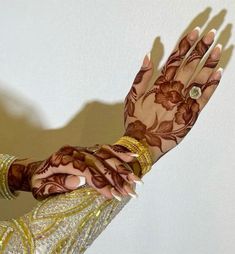 a woman's hand with henna on it