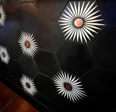 an artisticly designed black and white wall with sunbursts on it