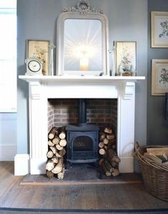 a living room with a fire place and pictures on the wall