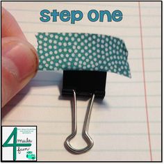 a hand holding a paper clip with the word step one on it