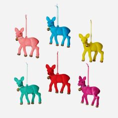 four different colored deer ornaments hanging from strings