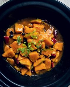 a black bowl filled with food on top of a table