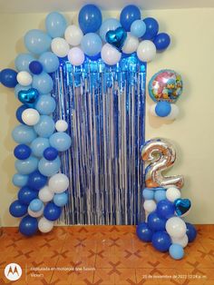 balloons and streamers decorate the entrance to a birthday party