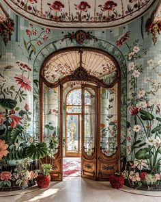 an ornate entry way with flowers painted on the walls and doors, along with potted plants