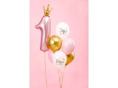 some balloons are in the shape of a number one with a crown on top and pink background