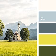 an image of a church in the middle of a field with mountains in the background