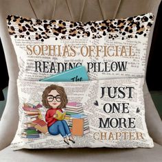 a pillow that is sitting on top of a chair with a book and leopard print