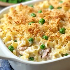 a casserole dish with peas and meat in it