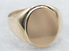 "This unisex signet ring has a modest profile on the hand and is completely un-decorated. These features make it versatile, an easy gift to give, and an easy ring to wear day-to-day.  Market Square Jewelers works with one of the finest hand engravers in the northeast. With over 30 years of experience, our engraver hand carves lettering, monograms, crests, or patterns in period-specific styles. Choose from our many monogram options shown in the listing or contact us directly with your own crest, monogram, or for additional information, and pricing! Metal: 10K Yellow Gold Width of Band: 15.7 mm Height off Finger: 2.3 mm Ring Size: 9.75 Marks: \"10K\" Stamped on the inside band To view a video of this piece check out the link below: https://vimeo.com/810551888 SKU #: A22006 Each piece has bee Market Square, Gold Statement Ring, Gold Signet Ring, Gold Gift, Ring Oval, Gold Pattern, Jewelry Companies, Easy Gifts, Unique Engagement Rings