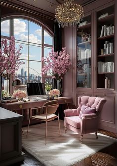 a pink chair in front of a desk with a laptop on it and flowers in vases