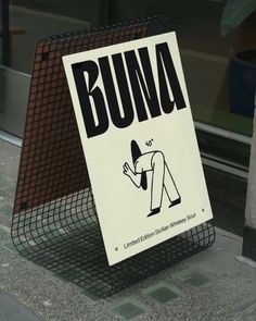 a sign that says buna on the side of a building next to a window