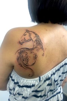 a woman with a horse tattoo on her back