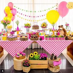 a table topped with lots of food and balloons