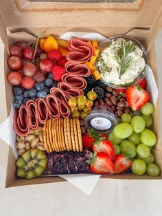 an open box filled with assorted fruits and veggies on top of a table