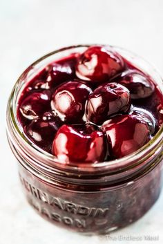 fresh cherry sauce in a mason jar with text overlay