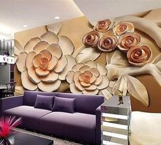 a living room with purple couches and large flower wall mural on the wall behind it