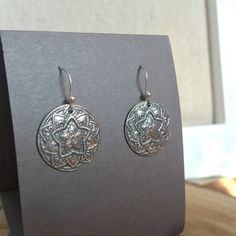 Inspired by an antique buttons, these silver mandala earrings are handmade. Each disc is carefully formed, torch fired and then hand polished in my studio. Sterling silver ear wires are also handmade. 1" length including ear wires .75" wide at widest point Buy with confidence, as all jewelry items are securely packaged and shipped promptly upon payment. Shop now and enjoy free shipping and gift wrap! Please browse my shop for more unique finds: www.bonnierosejewelry.com Additional Information: > Handmade Antique Silver Round Earrings, Handmade Medallion Sterling Silver Earrings, Silver Sterling Silver Medallion Earrings, Star Mandala, Mandala Earrings, Silpada Jewelry, Rose Jewelry, Antique Buttons, Hand Made Jewelry