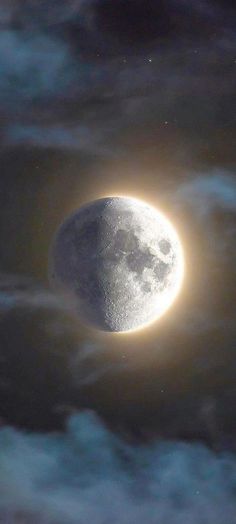 an image of the moon in the sky with clouds and stars around it, as seen from space